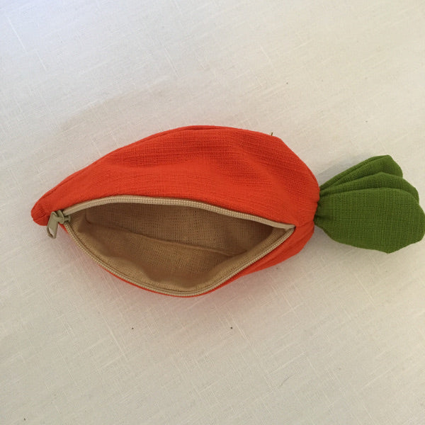 A carrot purse bursting with three bunnies