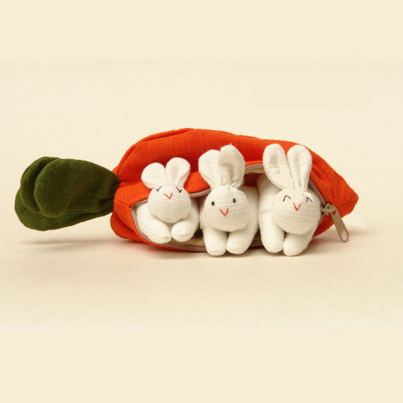A carrot purse bursting with three bunnies