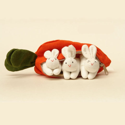 A carrot purse bursting with three bunnies