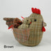 "Cluck  Cluck" marvellously plump Mother hen here with four small chicks safely nestled under her wings.