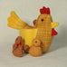 "Cluck  Cluck" marvellously plump Mother hen here with four small chicks safely nestled under her wings.