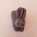 A carrot purse bursting with three multicultural bunnies